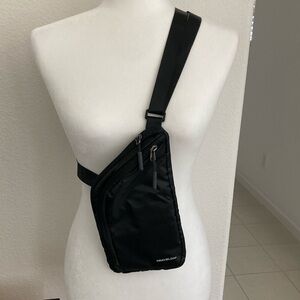 Brand New (tags off). Never used. Travelon slim crossbody bag.